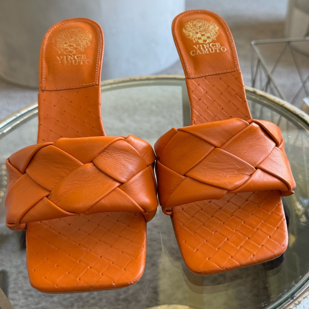 Orange Vince Camuto braided mules.